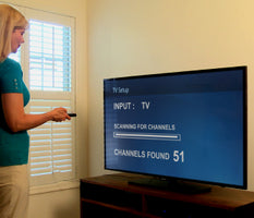 A woman scanning for channels through her Unlimited Antenna.