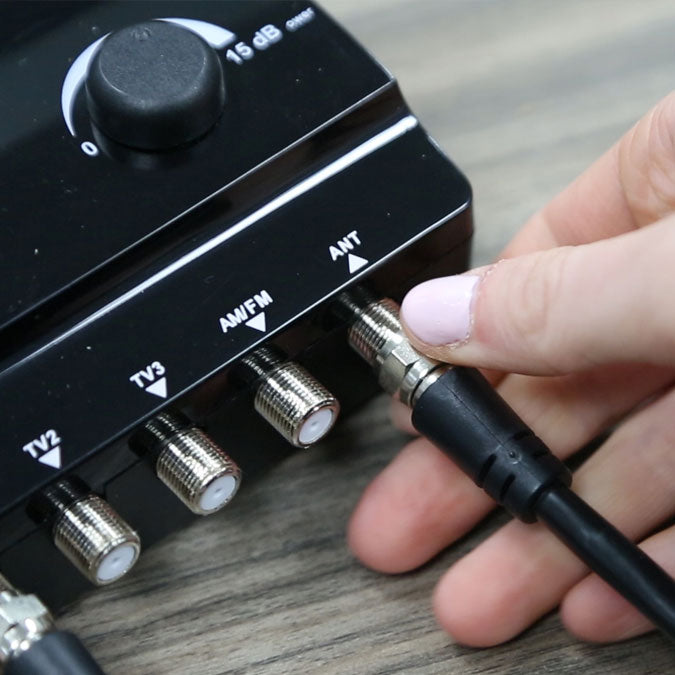 Cord being plugged into a TV signal booster.