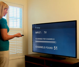 A woman scanning for channels through her Unlimited Antenna. 